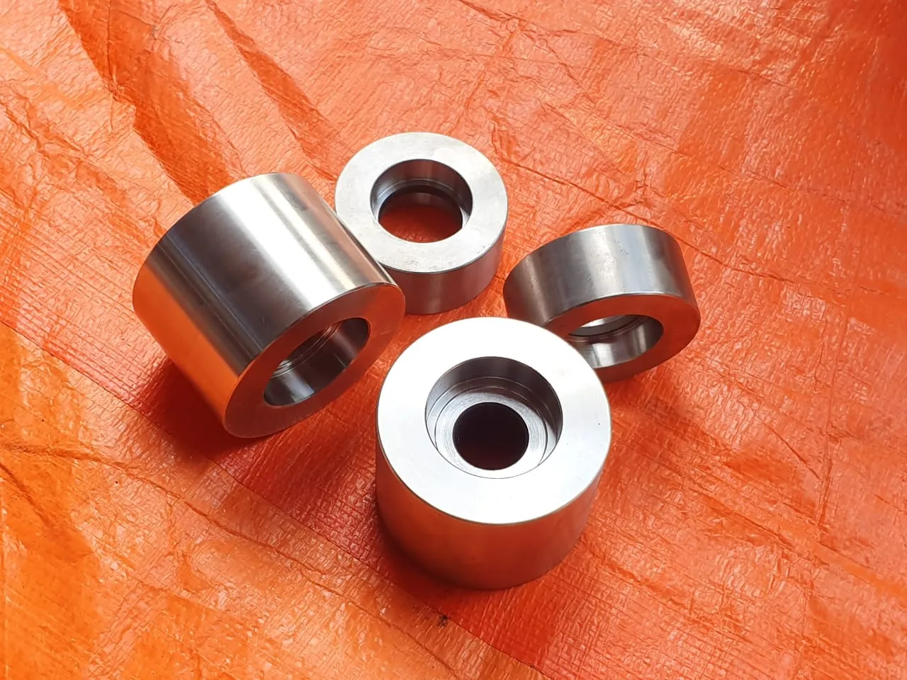 Turned guide rolls and bushings before assembly