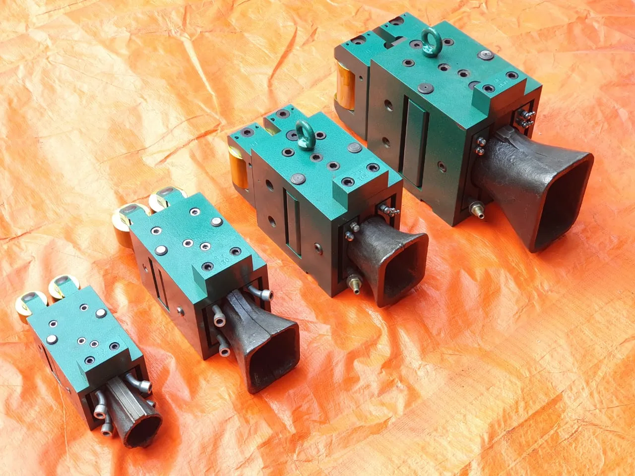 Row of finished guide boxes on their mounting plates