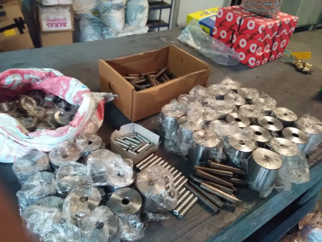 Bronze bushings, pins and guide spares on the workbench