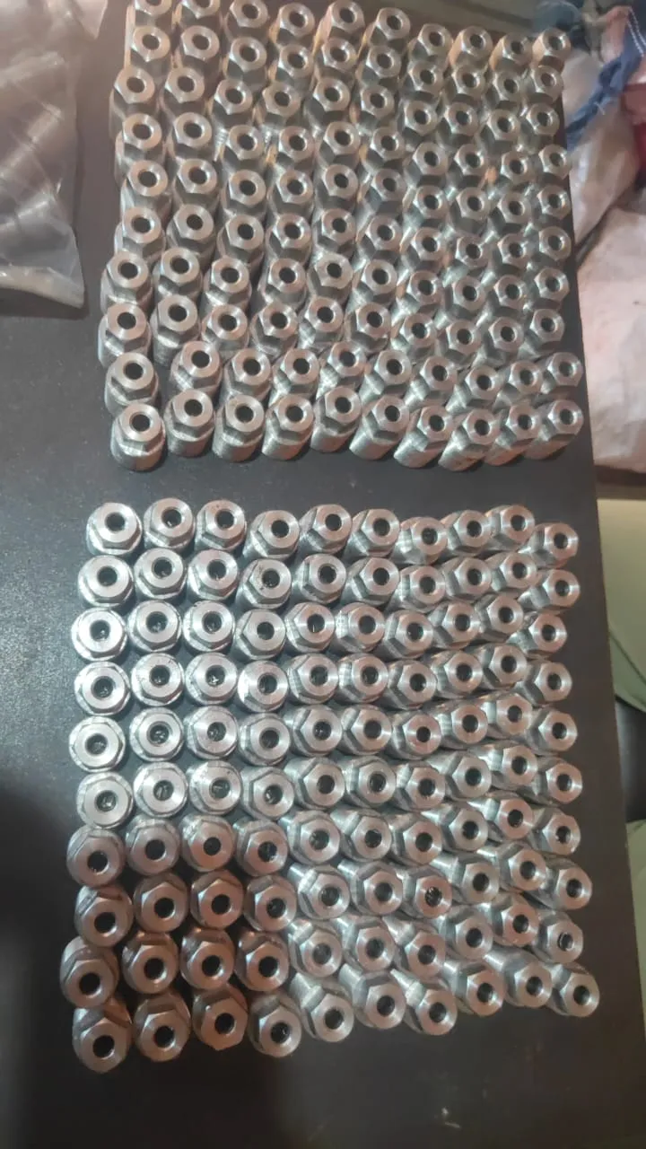 Machined bushings and spacers laid out for inspection